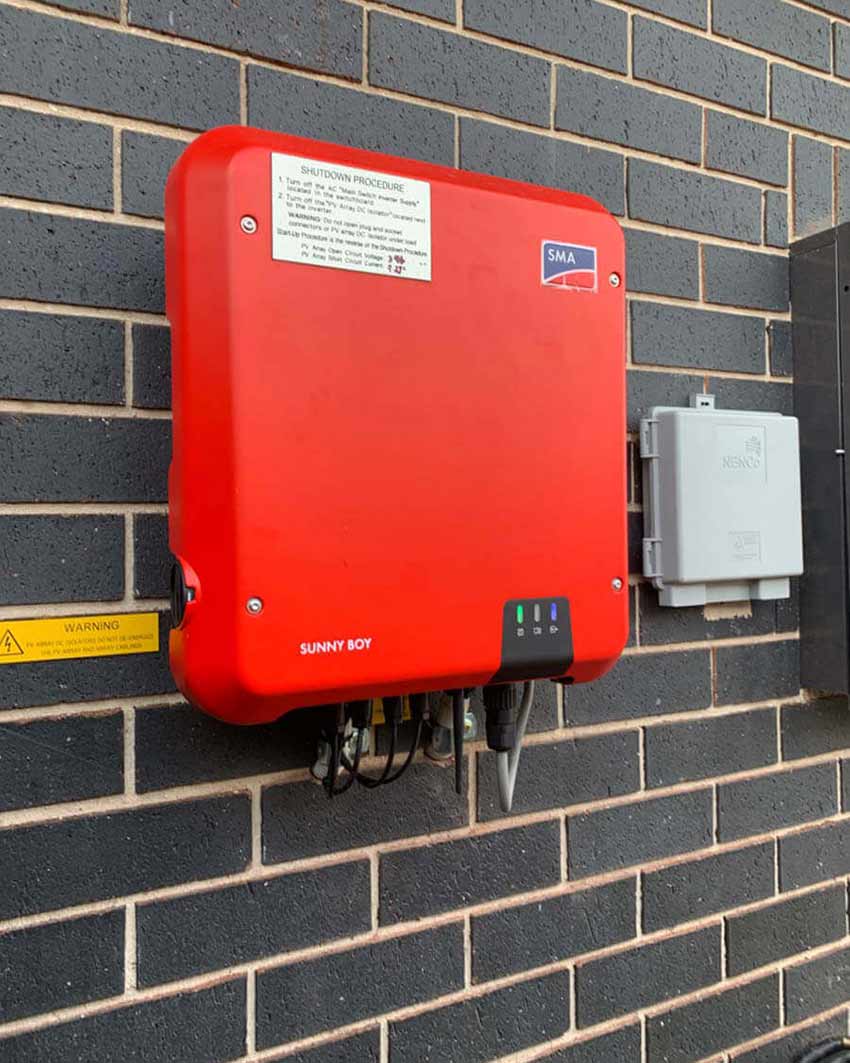 An Image of a red colored SMA Solar solution mounted on a wall